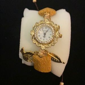 Strada watch made like bracelet with charms.